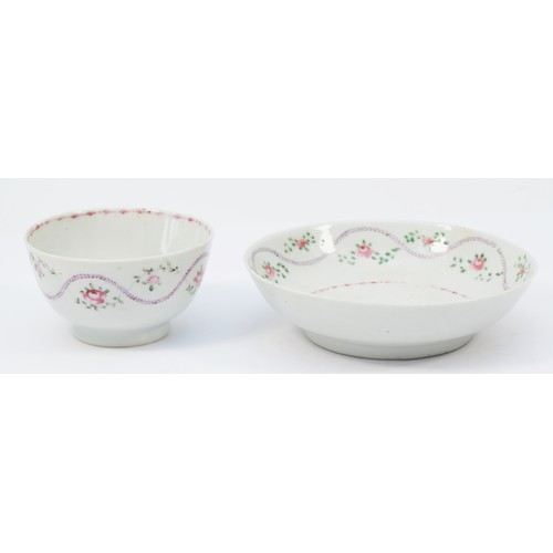 325 - A 19th century Newhall tea bowl & saucer, having floral garland and sprig decoration. (2)