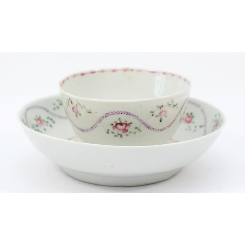 325 - A 19th century Newhall tea bowl & saucer, having floral garland and sprig decoration. (2)