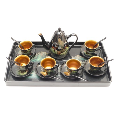 340 - A Japanese lacquerware tea set comprising of a tray, teapot, six tea cups with saucers and tea spoon... 