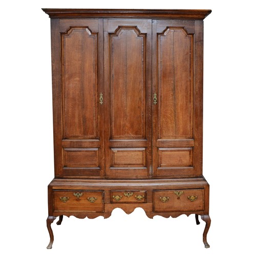 356 - A George III oak livery cupboard, projecting moulded cornice over two panelled doors, the upper pane... 