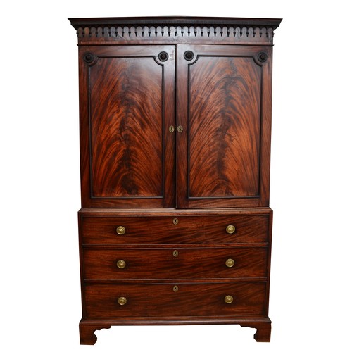 361 - A George III flame mahogany linen press, circa 1780s, the pierced cornice over a pair of beaded pane... 