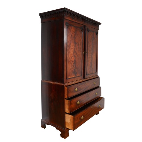 361 - A George III flame mahogany linen press, circa 1780s, the pierced cornice over a pair of beaded pane... 