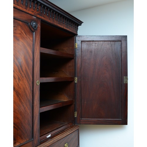 361 - A George III flame mahogany linen press, circa 1780s, the pierced cornice over a pair of beaded pane... 