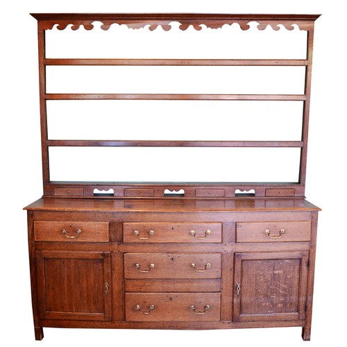 363 - A 19th century Georgian oak dresser, projecting cornice over shaped apron and three-tier plate rack,... 