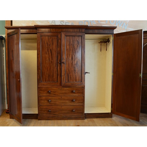 364 - A George III flame mahogany triple breakfront wardrobe, circa late 19th century, dentil moulded corn... 