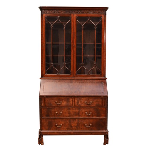 A George III mahogany bureau bookcase, moulded dentil carved cornice over two astragal glazed doors, enclosing three adjustable shelves, the bureau with fitted interior and inset leather skiver, over two short and two long drawers, on a skirted base terminating carved front and square back feet.
H208, W104, D45cm.