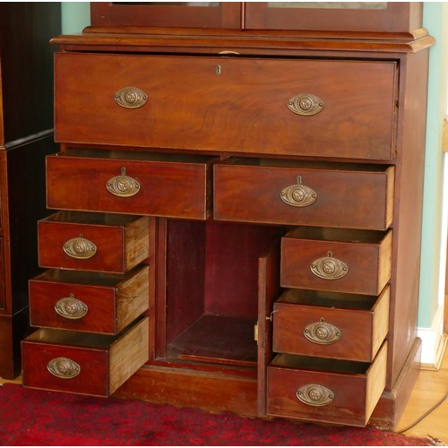 381 - A late 19th century mahogany secretaire bookcase, the top with a stepped pediment over two glazed do... 