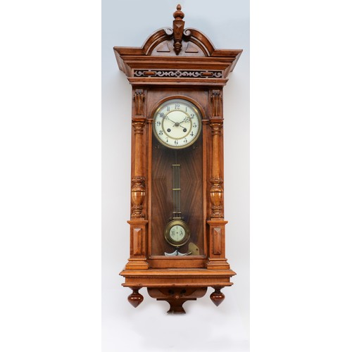 267 - A 20th century mahogany cased Vienna style wall clock, with a stepped pediment and finials, the two ... 