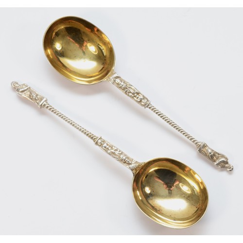 9 - A Victorian silver pair of serving spoons, makers mark poorly struck, London 1881, the cast handles ... 