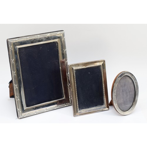 19 - A silver rectangular photograph frame, Sheffield 1996, 22 x 17cmand two other silver photograph fram... 