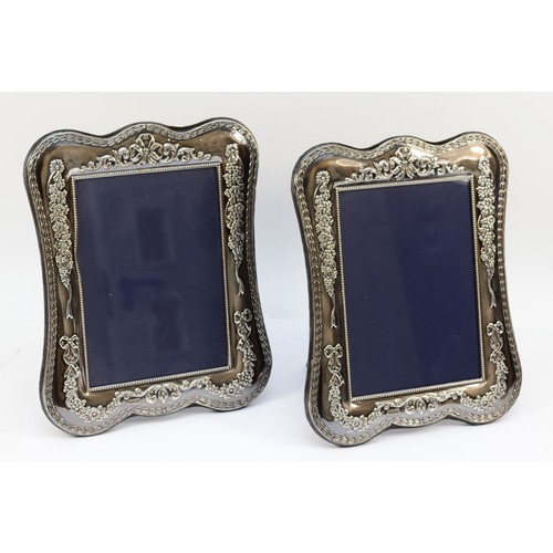 21 - A pair of large silver photograph frames, Sheffield 2000, Millennium mark, 25 x 20cm (2).