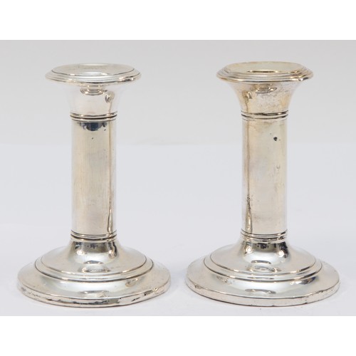 33 - A silver pair of desk candlestick, Birmingham 1935, loaded, 11cm