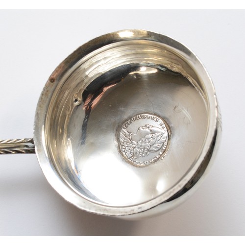 41 - A George III silver and whalebone ladle, unmarked, the bowl inset with a 1757 silver coin, contempor... 