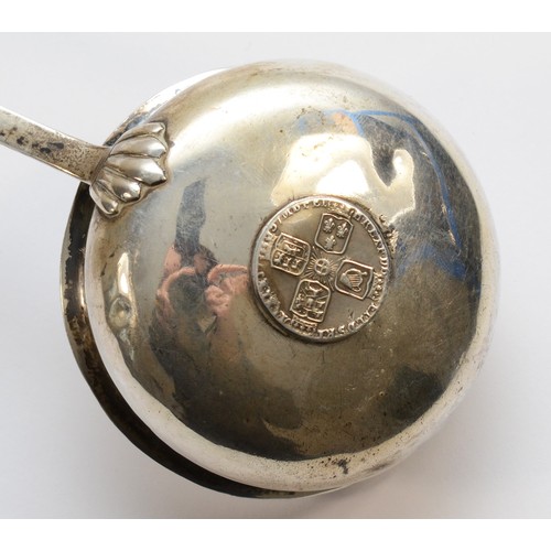 41 - A George III silver and whalebone ladle, unmarked, the bowl inset with a 1757 silver coin, contempor... 