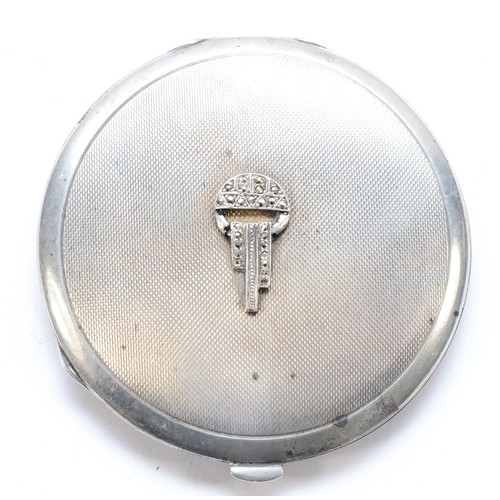 79 - An Art Deco silver and marcasite mounted powder compact, Birmingham 1934, opening to reveal a mirror... 