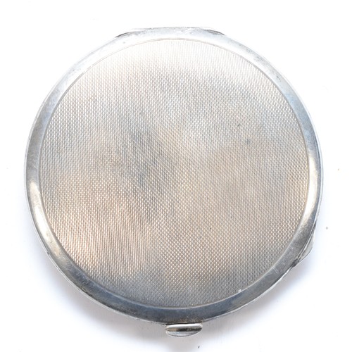 79 - An Art Deco silver and marcasite mounted powder compact, Birmingham 1934, opening to reveal a mirror... 