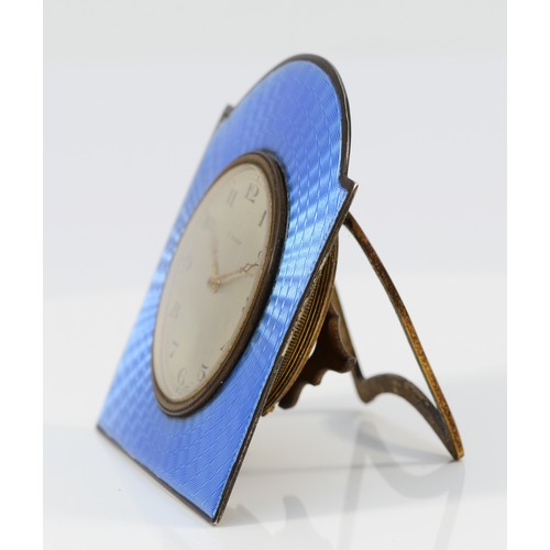 105 - An Art Deco silver and blue guilloche enamel bedside eight day clock, Birmingham 1928, 8 x 7cm, work... 