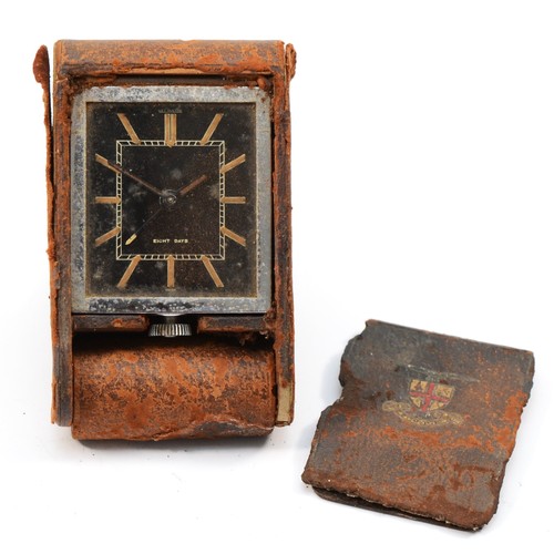 122 - Le Coultre, a vintage 8 day manual wind travel alarm clock, the leather case with City of London cre... 