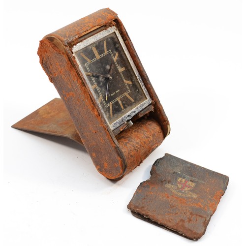 122 - Le Coultre, a vintage 8 day manual wind travel alarm clock, the leather case with City of London cre... 