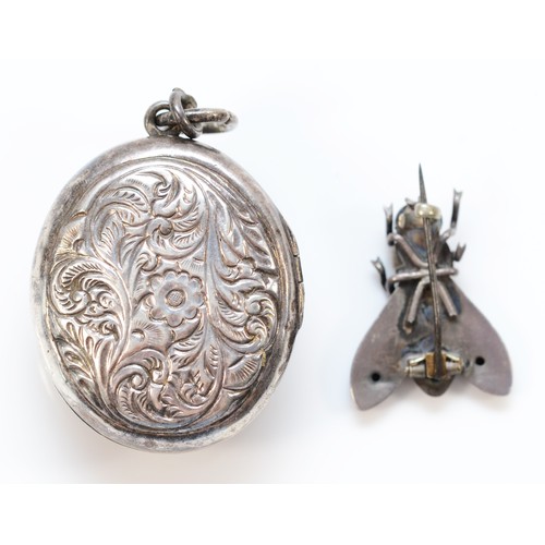 157 - An Indian silver embossed locket, depicting a deity, 37 x 34mm and a silver fly brooch, 29gm