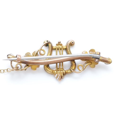 215 - A Victorian 9ct rose gold red stone and half pearl harp and clover leaf brooch, Birmingham 1892, 38m... 