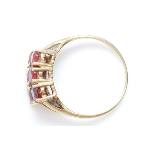 217 - A 9ct gold and six orange gemstone ring, N 1/2, 2.4gm