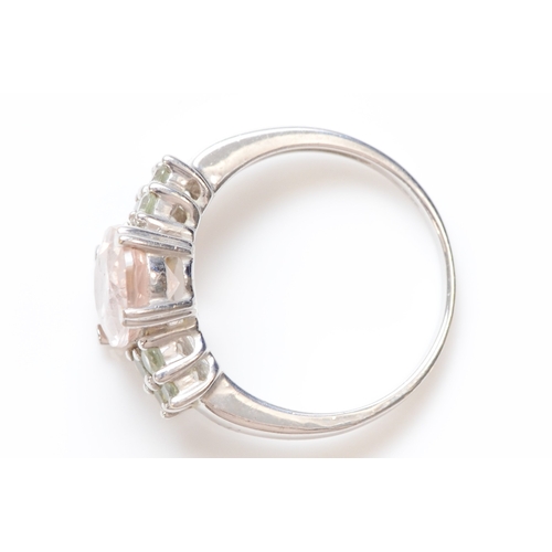 219 - A 9ct white gold morganite and pale green gemstone dress ring, O, 3.7gm