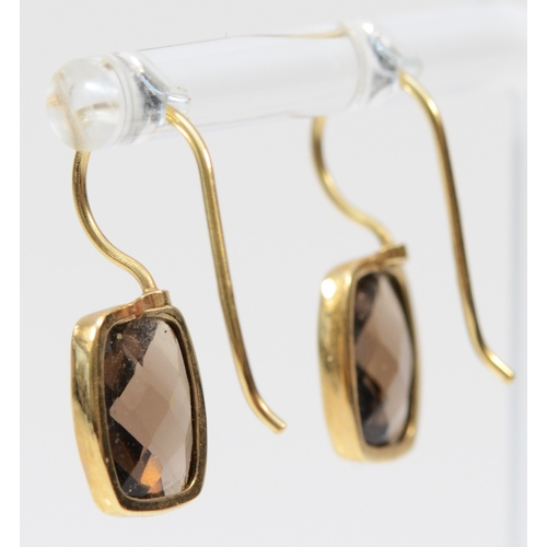 276 - A 9ct gold mounted pair of multi facetted smokey quartz ear rings, stones 10 x 8mm, 2.1gm