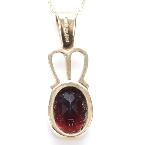 278 - A 9ct gold and garnet pendant, Millennium mark, 21mm overall, chain, 2.2gm