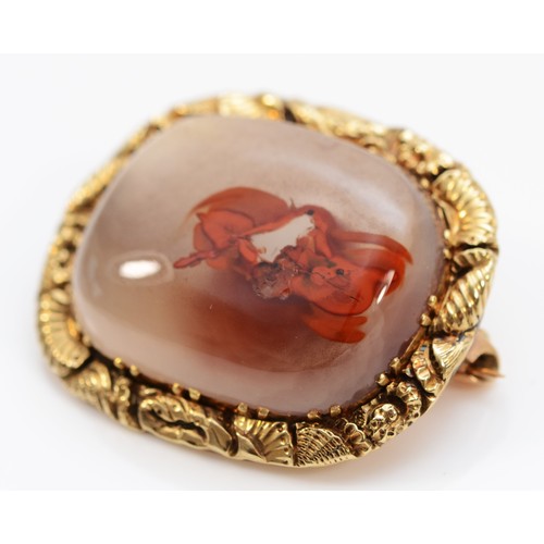 325 - A Georgian unmarked gold and agate mounted brooch, the frame with carved shells and flowers, 28 x 24... 