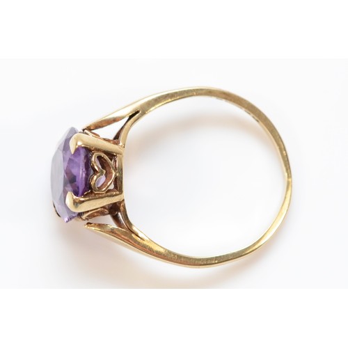 327 - A 9ct gold oval cut amethyst dress ring, claw set, M 1/2, 2.9g