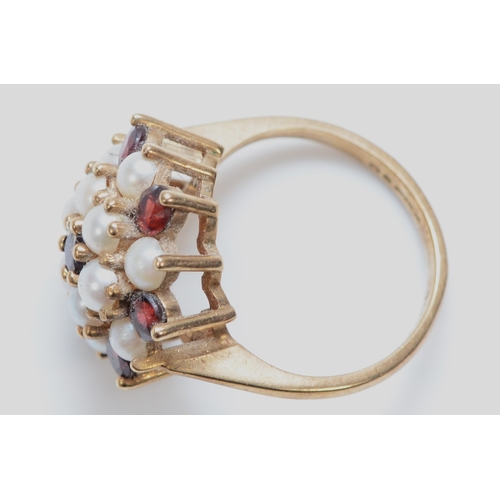 335 - A 9ct gold garnet and seed pearl cluster ring, J, 3.9g