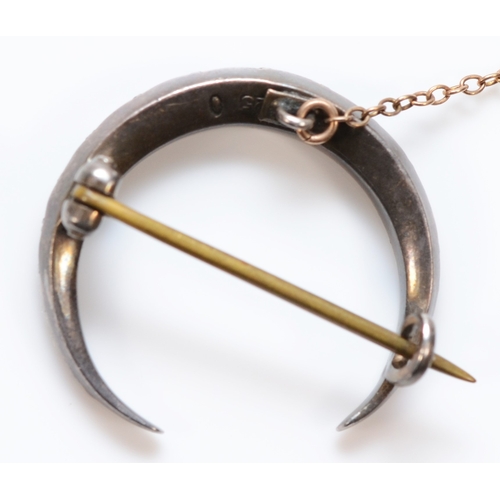 360 - A 925 silver clear paste crescent moon brooch with 9ct gold safety chain and base metal pin, 23mm di... 