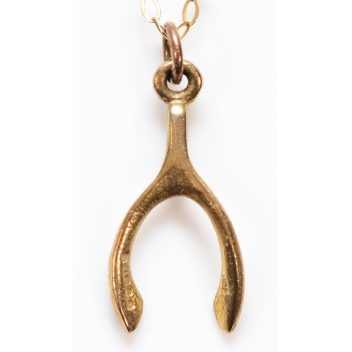 397 - A 9ct gold wishbone pendant with a 9ct gold chain, pendant measures 17mm, 0.9g