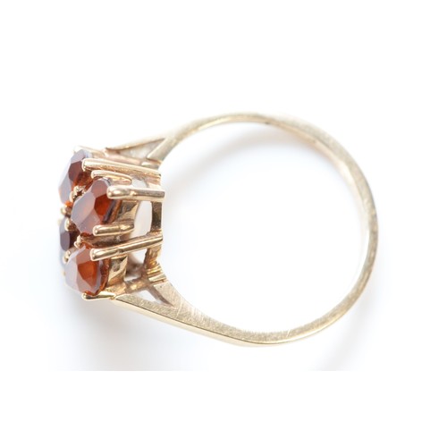 425 - A 9ct gold and four orange stone dress ring, N, 2.9gm