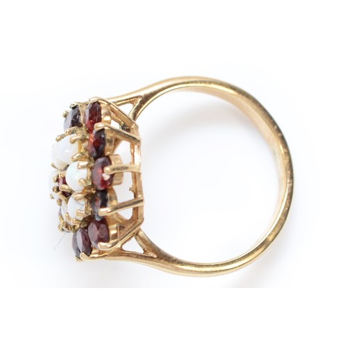 454 - A 9ct gold opal and garnet cluster ring, diameter 17mm, P, 4.8gm