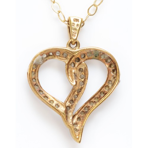 469 - A 9ct gold and diamond open heart pendant, stated weight 0.25cts, 24 mm overall, chain, 3gm