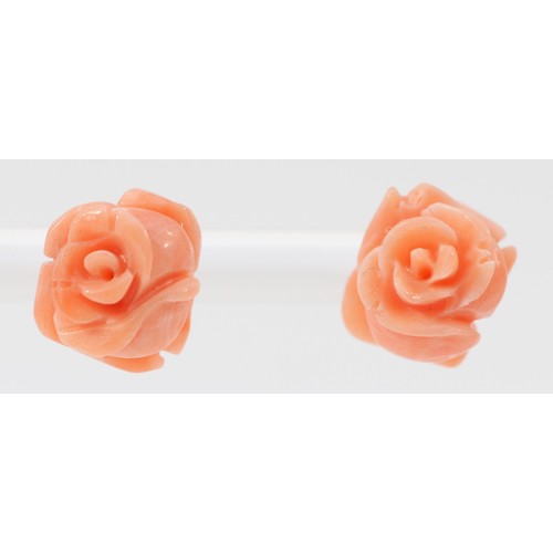 527 - A pair of 14K gold mounted carved coral rose ear studs, diameter 10mm