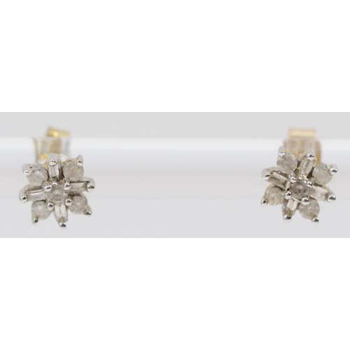 533 - A 9ct white gold pair of brilliant and baguette cut diamond cluster ear studs, 0.9ct