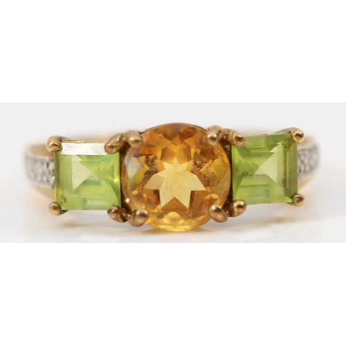 535 - A 9ct gold citrine and peridot three stone ring, diamond set shoulders, R, 3.3gm