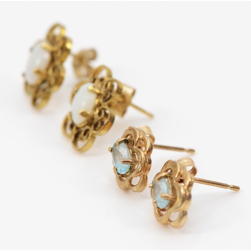 556 - A 9ct gold pair of opal ear studs and a topaz pair, 1.9gm