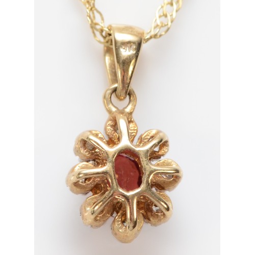 564 - A 9ct gold red gemstone and diamond pendant, chain, 1.8gm