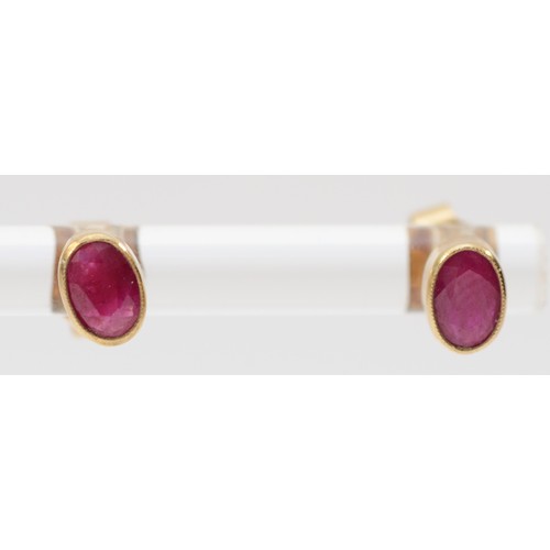 590 - A 9ct gold pair of 6mm ruby ear studs, 0.9gm