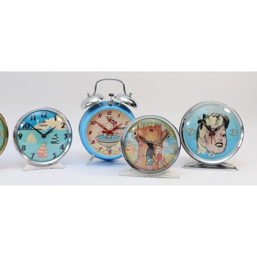 Eight novelty alarm clocks, with designs including Mickey Mouse, Snoopy