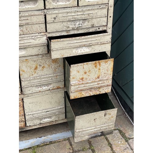 25A - An mid 20th century painted metal storage cabinet, comprising seven banks of various sized drawers.
... 