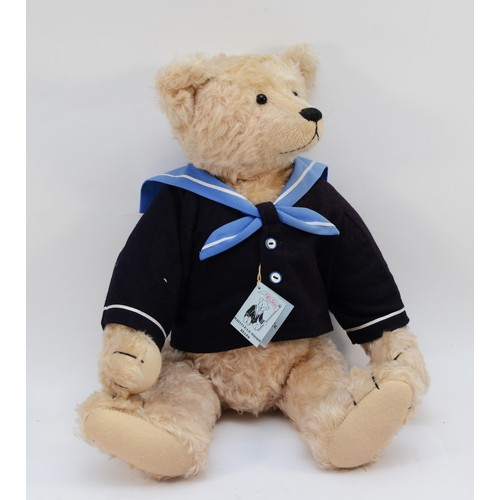 Whittle-Le-Woods Bears Nelson, artist designed growling teddy bear by Irene and Mike Whittle (UK), golden mohair, black glass eyes, black vertically stitched nose, fully jointed, felt pads, wearing blue wool jacket, swing label certificate, very good condition, 36cm.