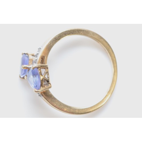 3 - A 9ct gold trillion cut tanzanite and white gemstone cross-over ring, M, 2.4g