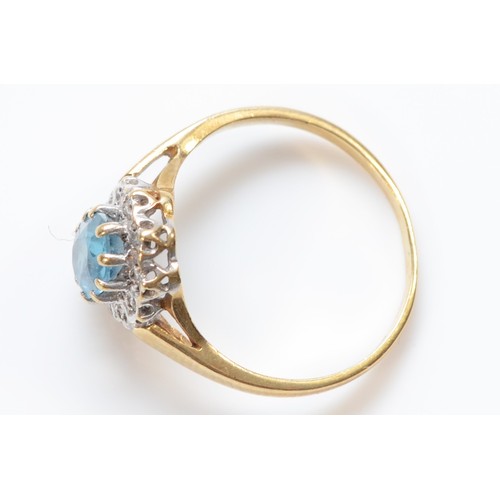 27 - A 9ct gold oval cut blue topaz and diamond cluster ring, claw set, J 1/2, 1.8g