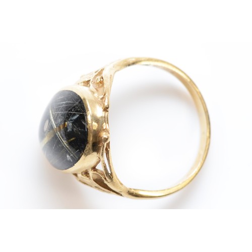 30 - A 9ct gold cabochon cut rutilated quartz dress ring, bezel set with floral patterned shoulders, R, 5... 