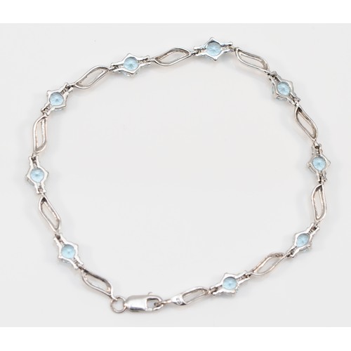 56 - A 9ct white gold blue topaz and cubic zirconia bracelet, 17cm, 4.9g